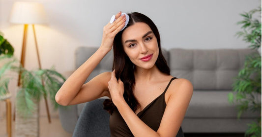 woman using a scalp massager for healthy scalp